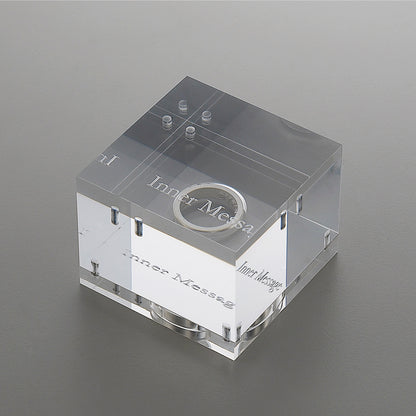 A captivating acrylic case, carefully crafted to complement the elegance of the Inner Message ring, offering a unique and stylish presentation for this designer masterpiece