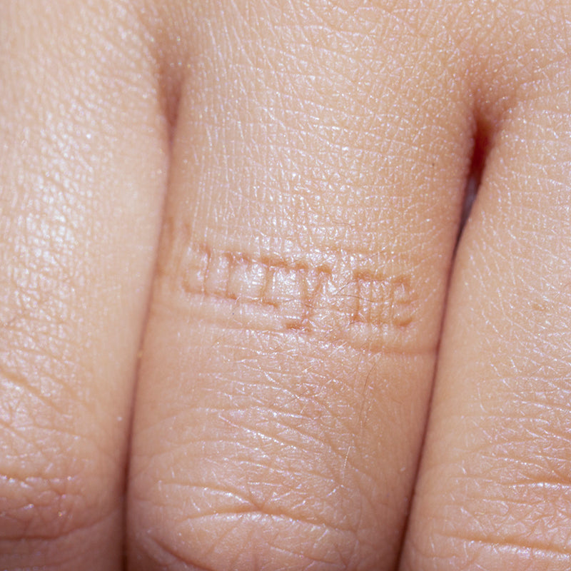  A photograph capturing the distinct 'Marry me' impression left on a finger by the Inner Message ring