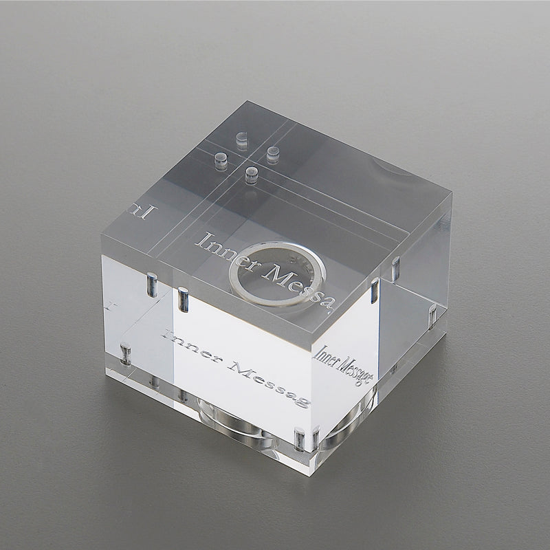  A perspective view of the unique and beautiful acrylic case designed for the Heart Inner Message ring, a designer-crafted piece